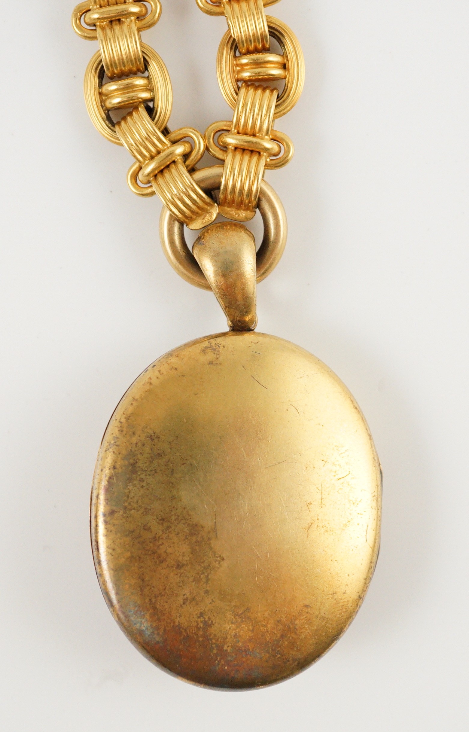 A Victorian gold, enamel and seed pearl set oval locket, on a 19th century Vienna 580/1000 gold chain